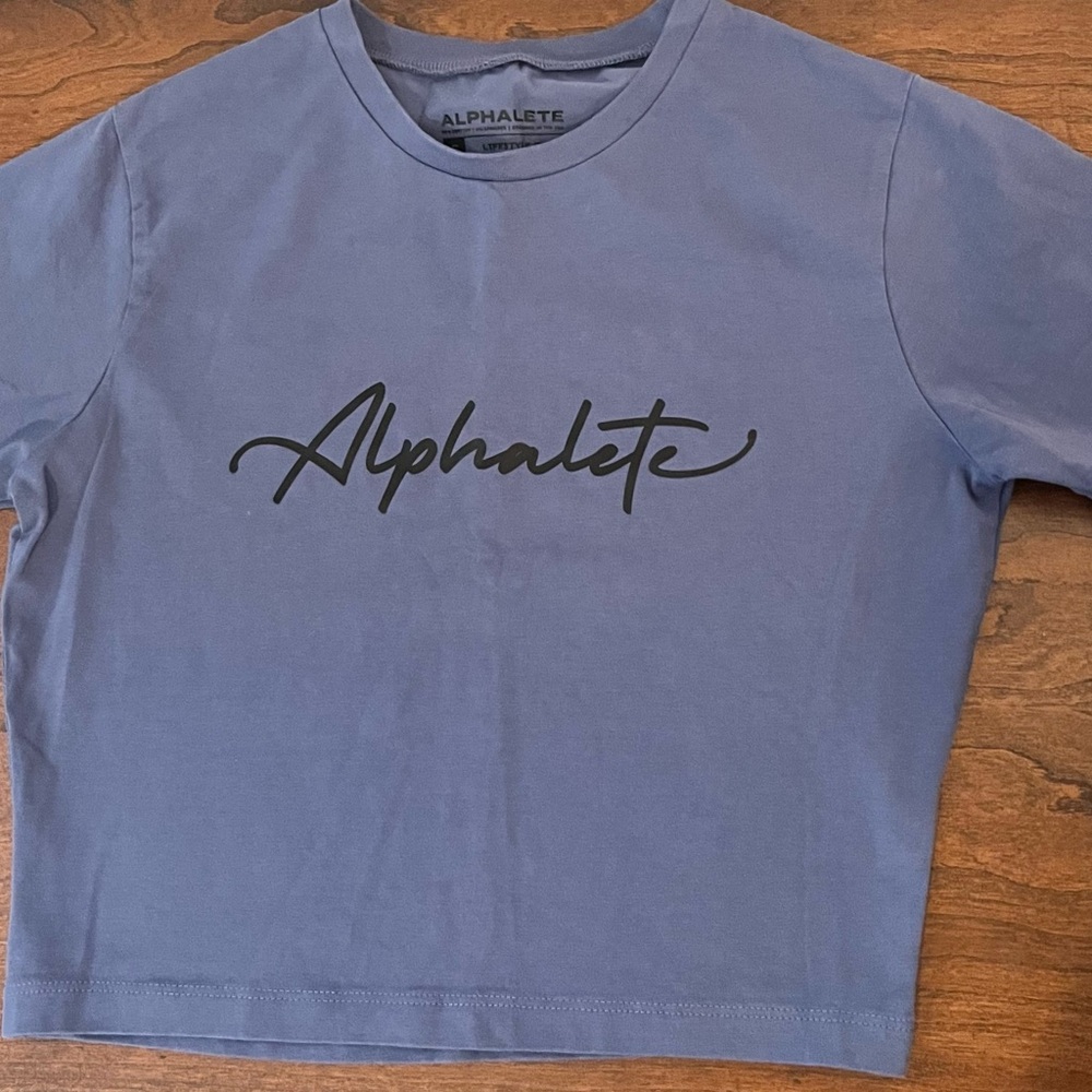 Alphalete Women’s Short Sleeve Crop Tee in Blue with Black Logo